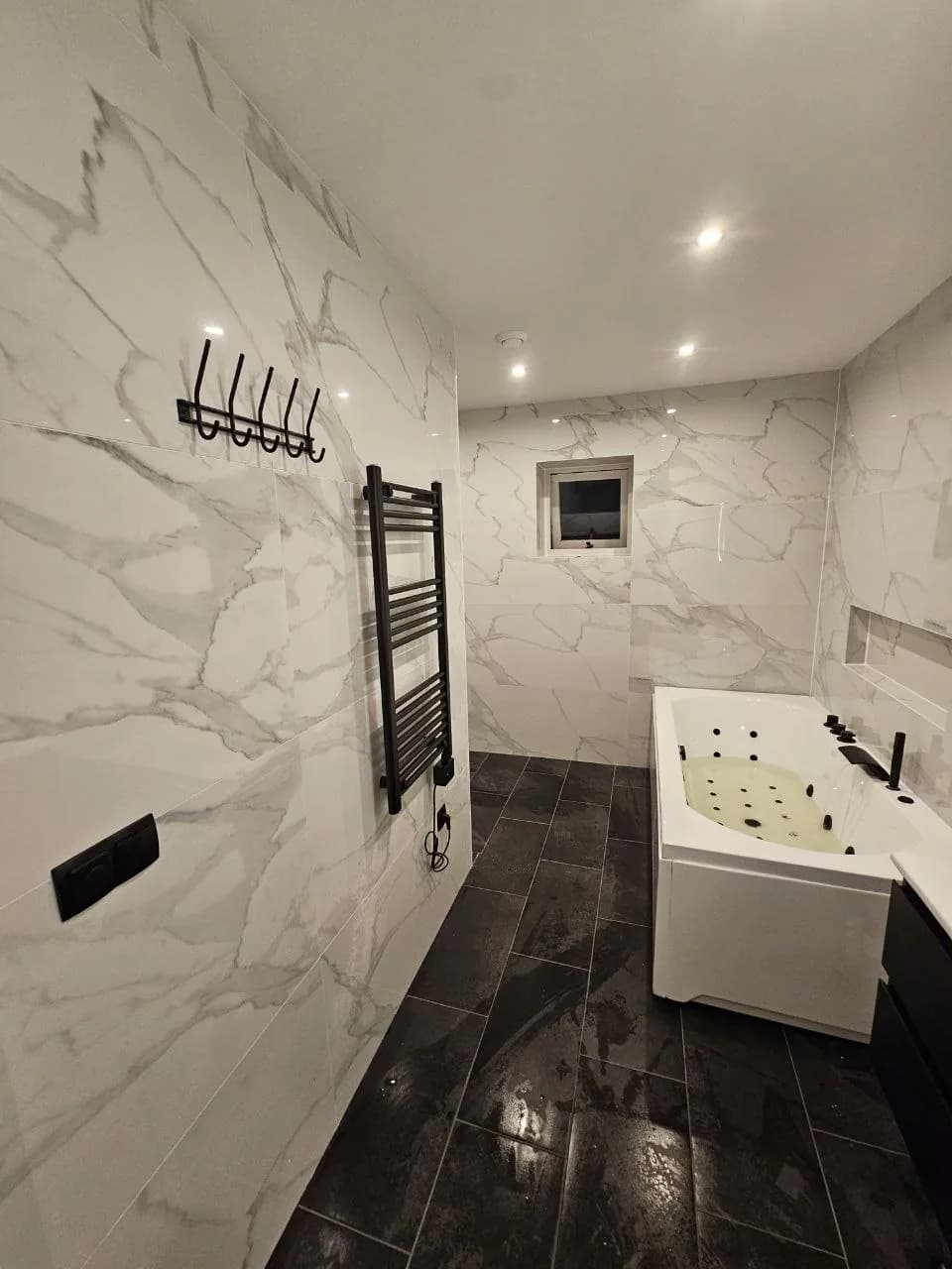 Marble-look bathroom with whirlpool bath