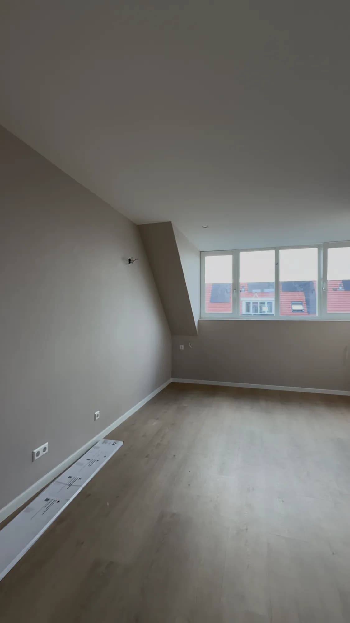 Attic room with laminate floor and painted walls